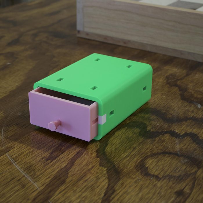 A 2x4 drawer module in green with the pink drawer pulled open